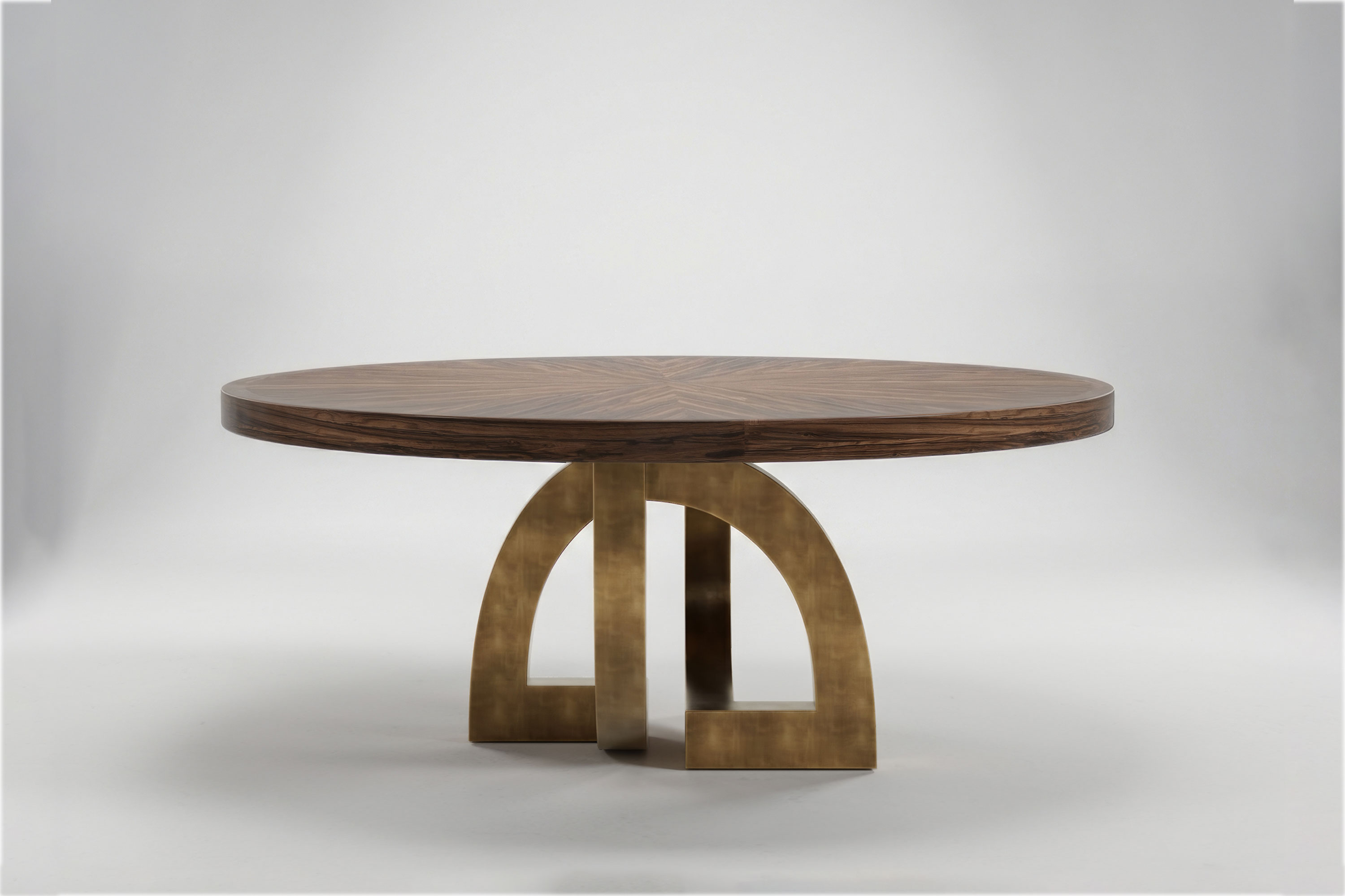 Arco Round dining table by Palena Studio, front view of the sunburst Macassar Ebony top on a patina bronze base of interlocking arches