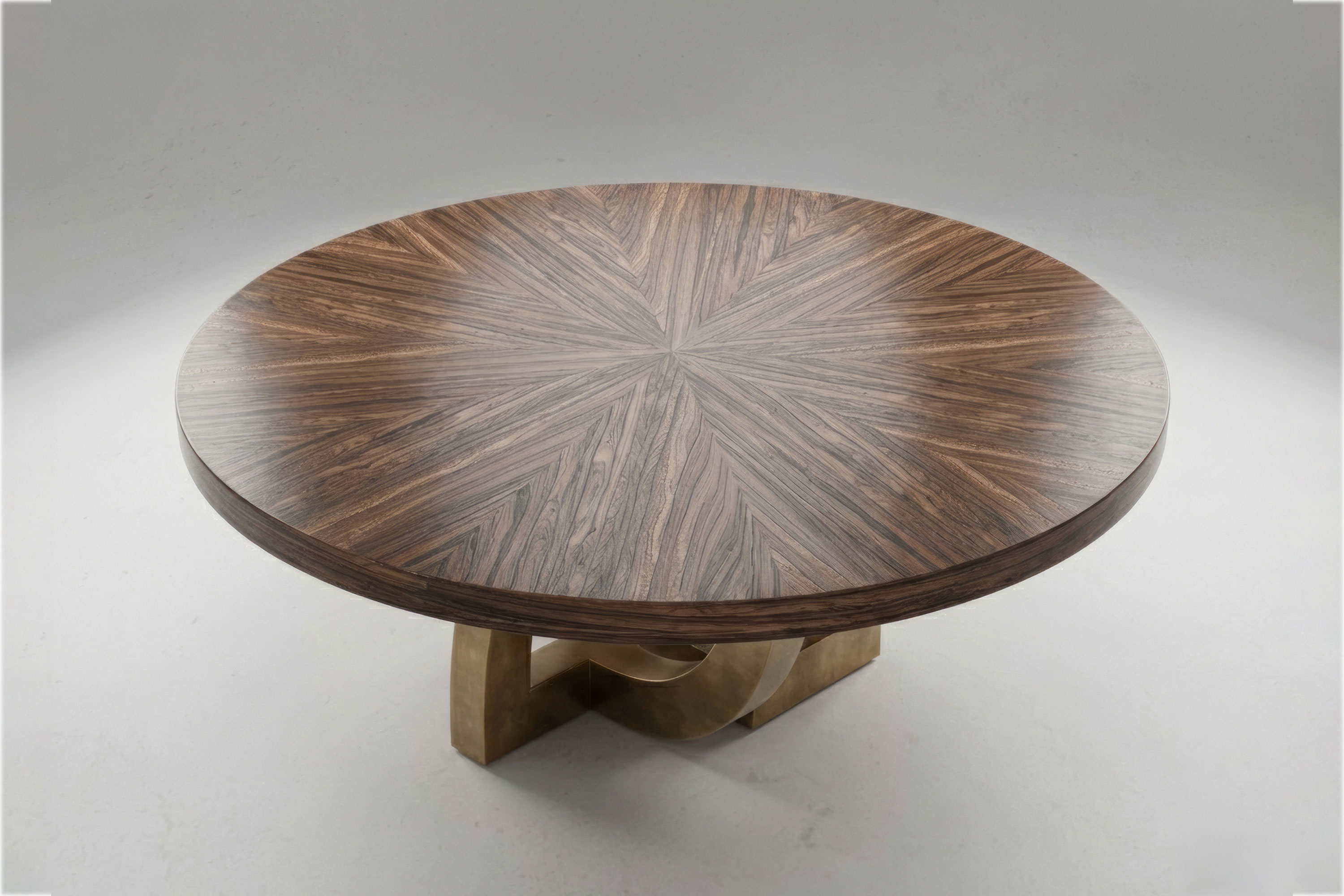 Arco Round dining table by Palena Studio seen from above, the hand-matched sunburst Macassar Ebony top on a patina bronze arch base