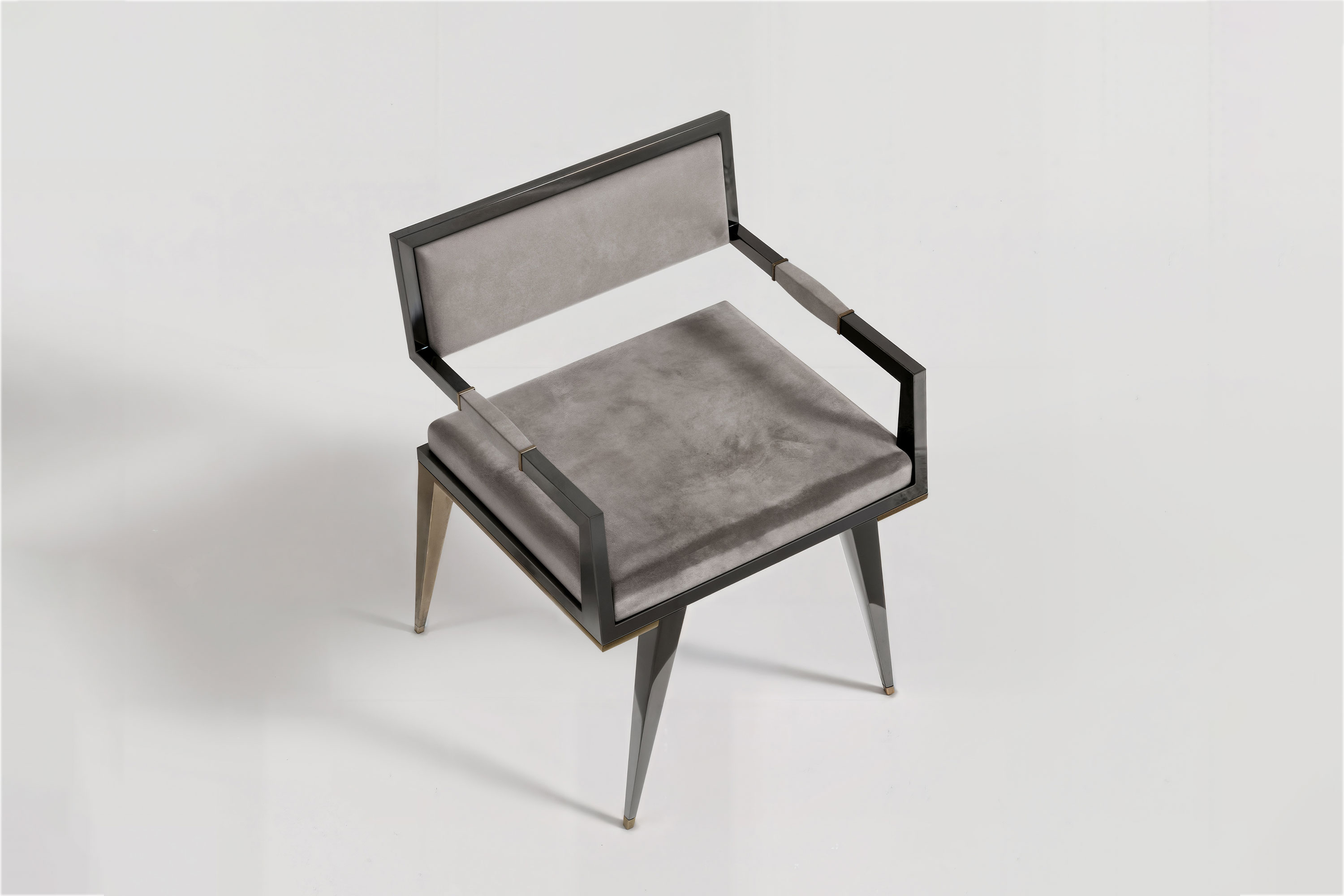Le Loup chair viewed from above, showing the open arms and the seat within its lacquer frame.