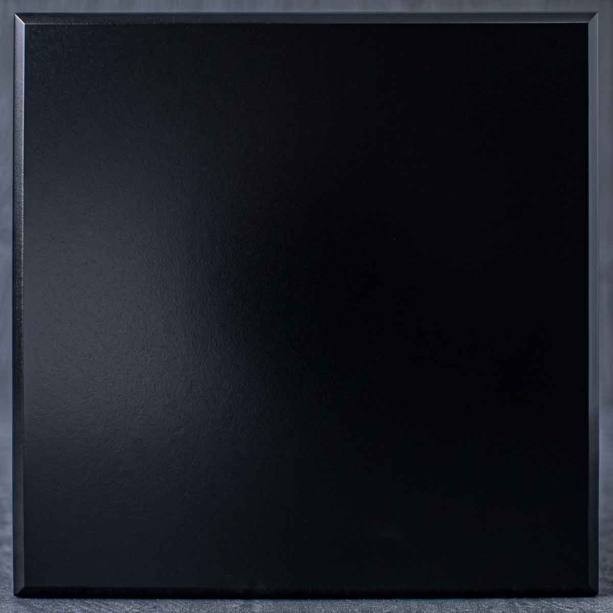 A deep, light-absorbing black finish with a smooth, tactile texture. It offers a sleek, understated elegance perfect for grounding modern designs.