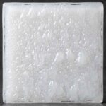 A highly opaque, milky-white glass featuring a tactile, cloud-like surface texture. This heavy-diffusion glass is ideal for sleek, minimalist backsplashes or cabinet inserts where visibility must be completely blocked.