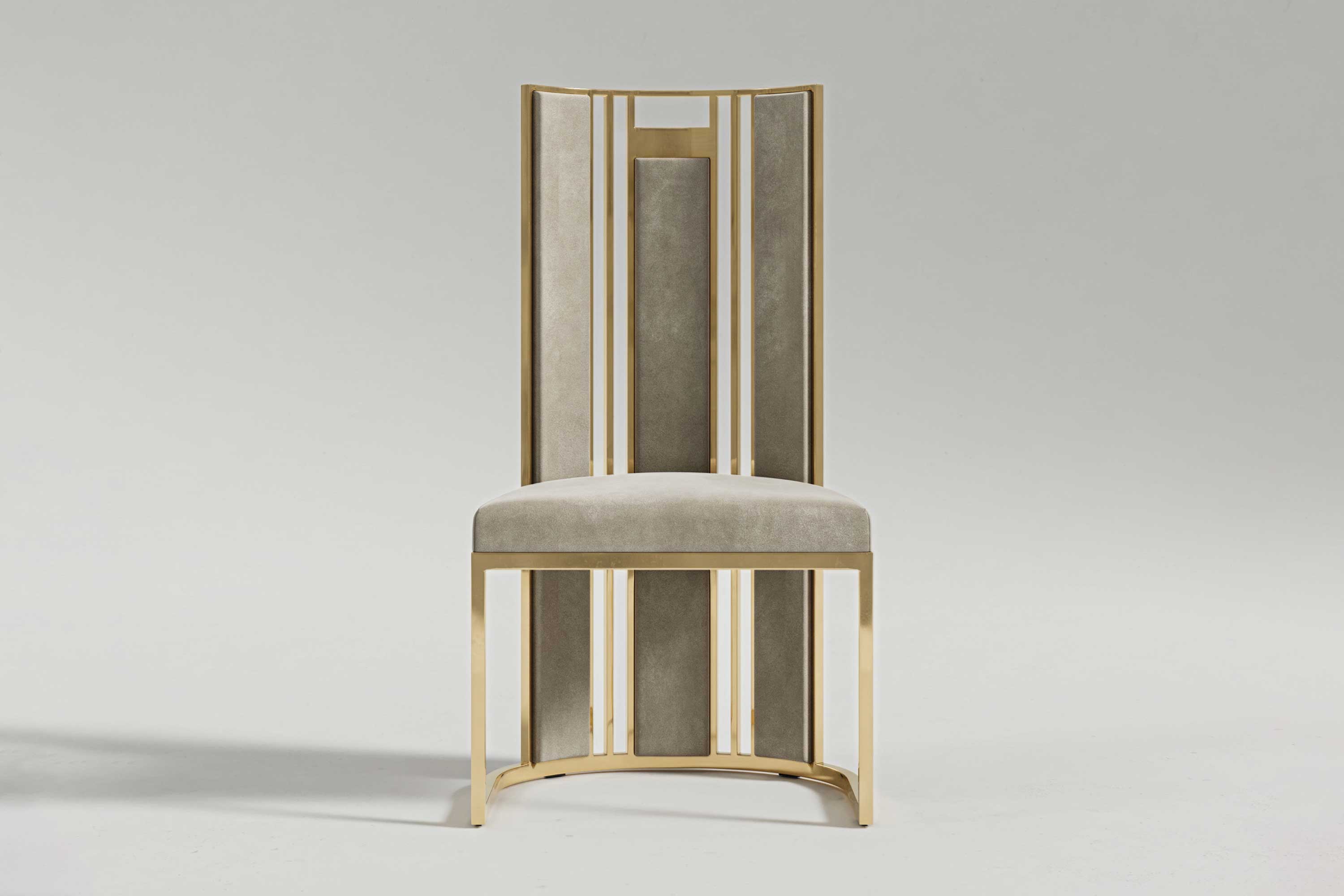 Colonna chair from the front, the full height of its fluted polished bronze back above a curved base.