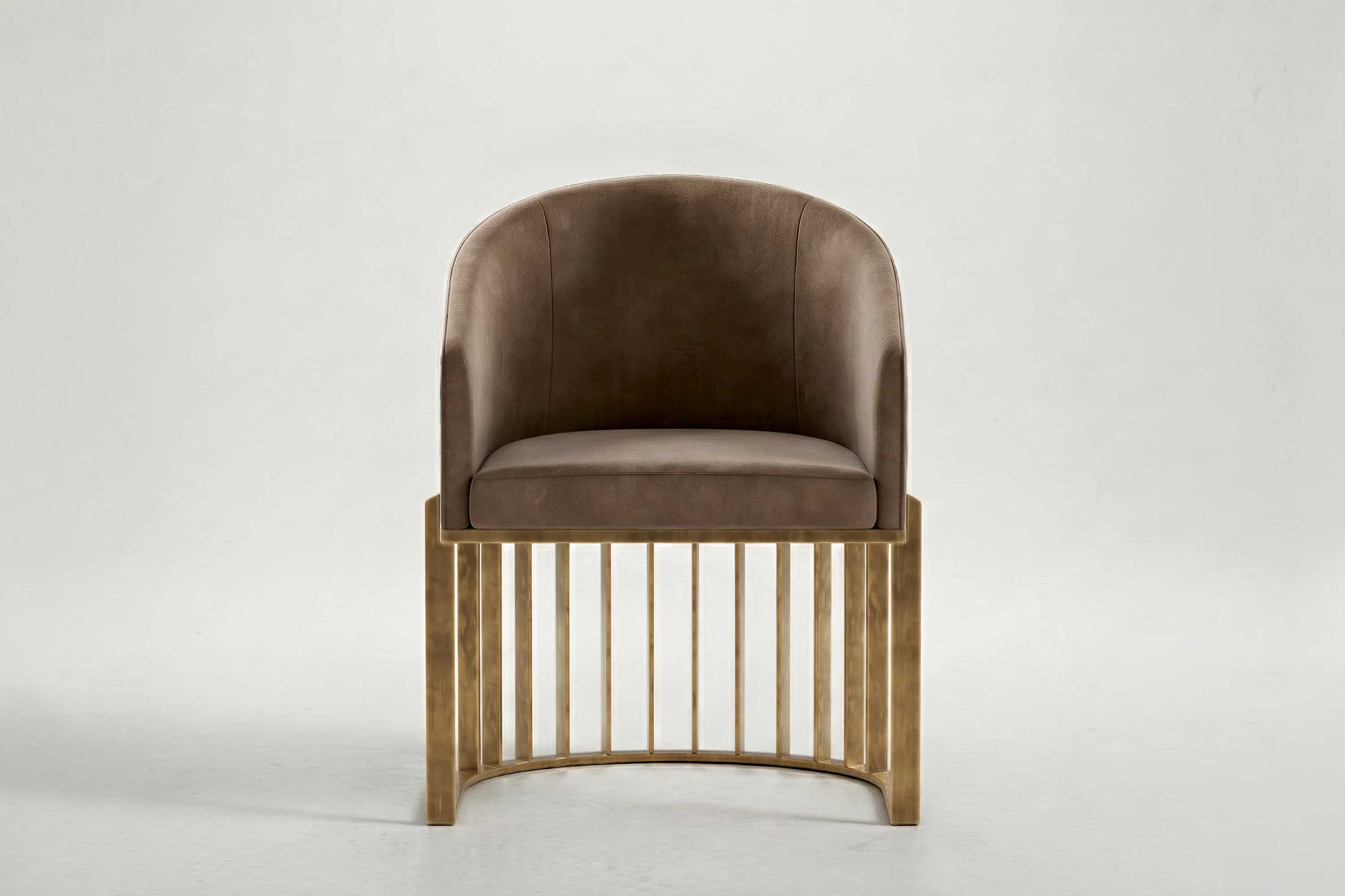 Modern chair with a brown upholstered seat and curved backrest, set on a gold metal base with vertical bars, against a plain light gray background. This handmade piece features subtle Artdecoo influences in its elegant design.
