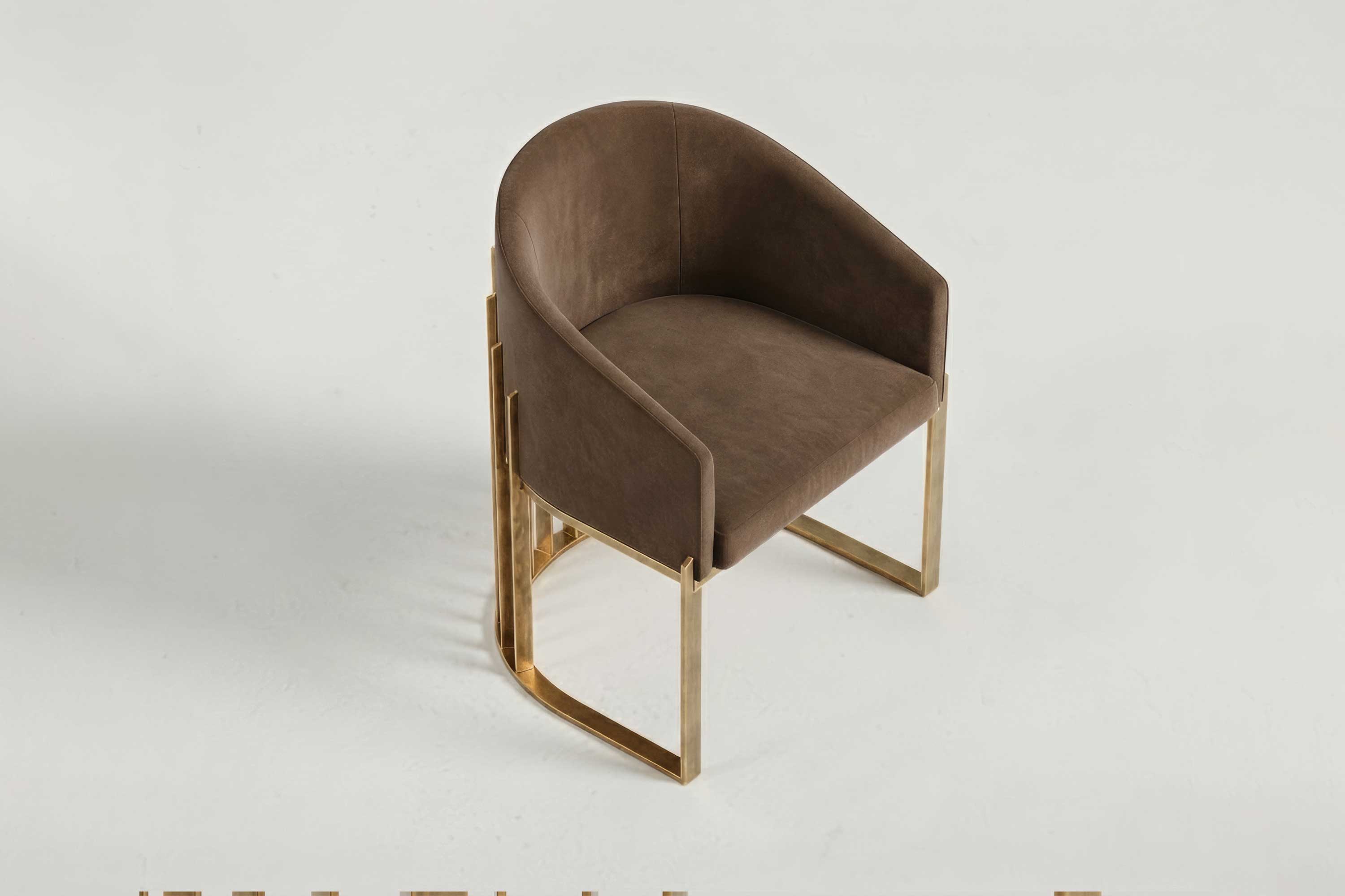 A brown, modern accent chair with a curved backrest and bronze metal legs, placed on a plain white background, showcasing Artdecoo-inspired bespoke furniture design.