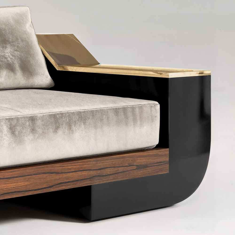 Close-up of the Meilleur Nom sofa's polished bronze armrest corner