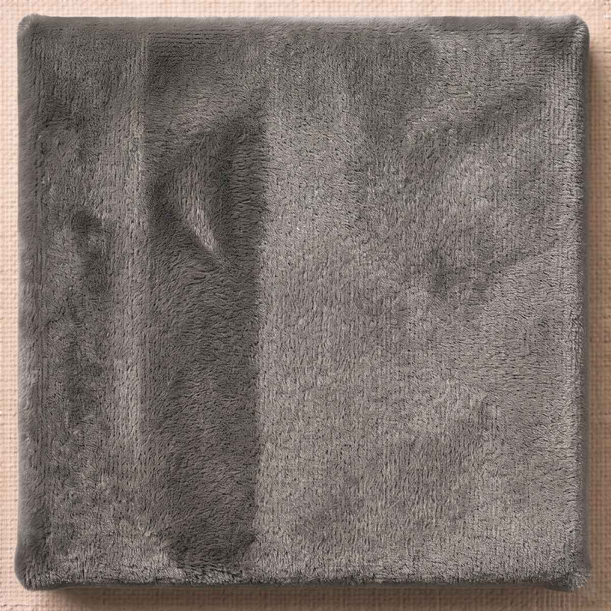 A deep, dense plush mohair in versatile slate grey. Offers tactile warmth and a substantial, enveloping pile suited for cozy, sophisticated collectible forms.