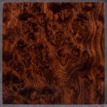 An exceptionally rich, reddish-brown wood characterized by mesmerizing, swirling burl figures. A rare and captivating choice that brings pure organic artistry to bespoke furniture.