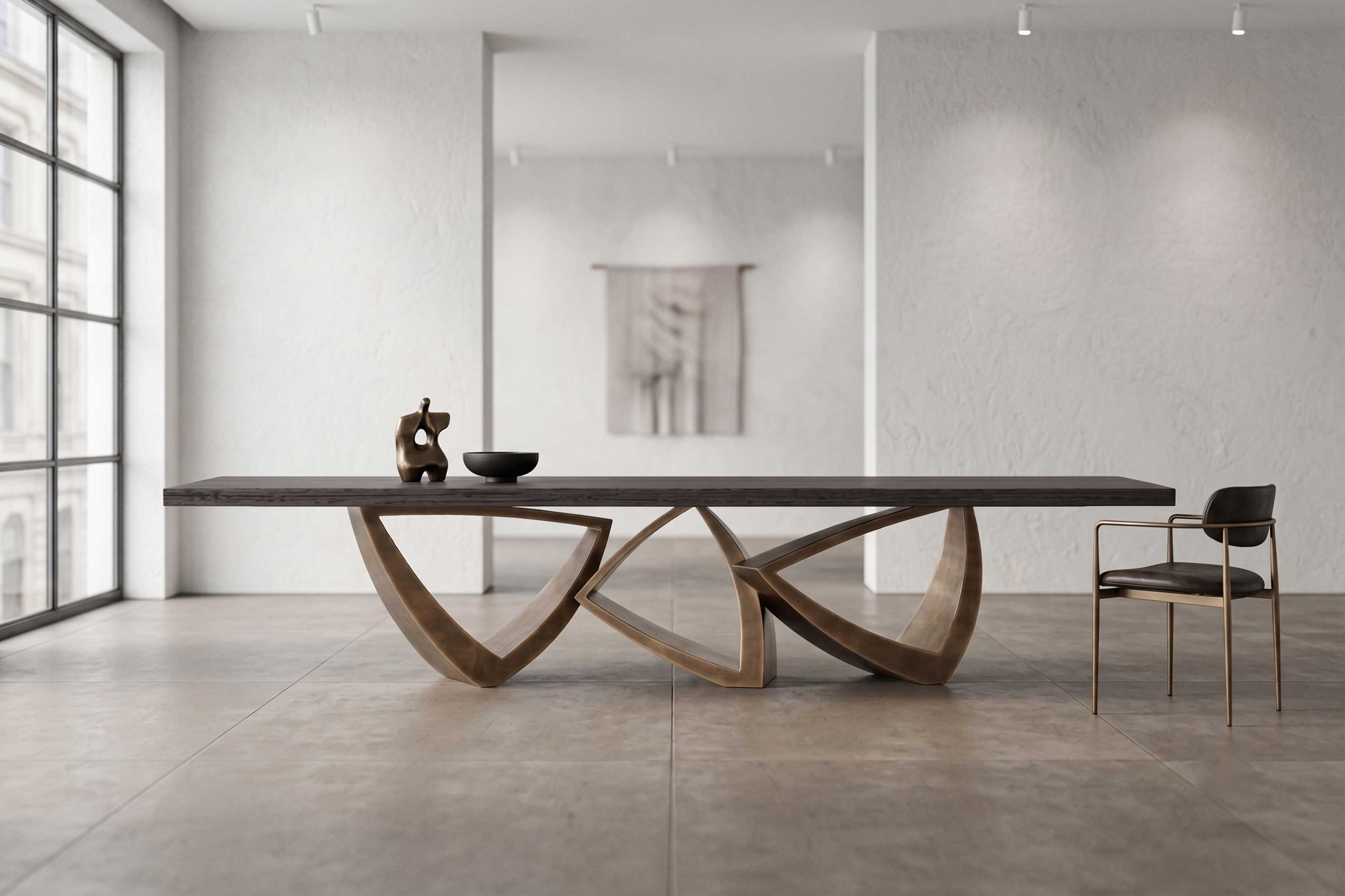 Arcos Dining Table in patina bronze, sculptural arc-base dining table staged in a bright minimal interior — Palena Studio