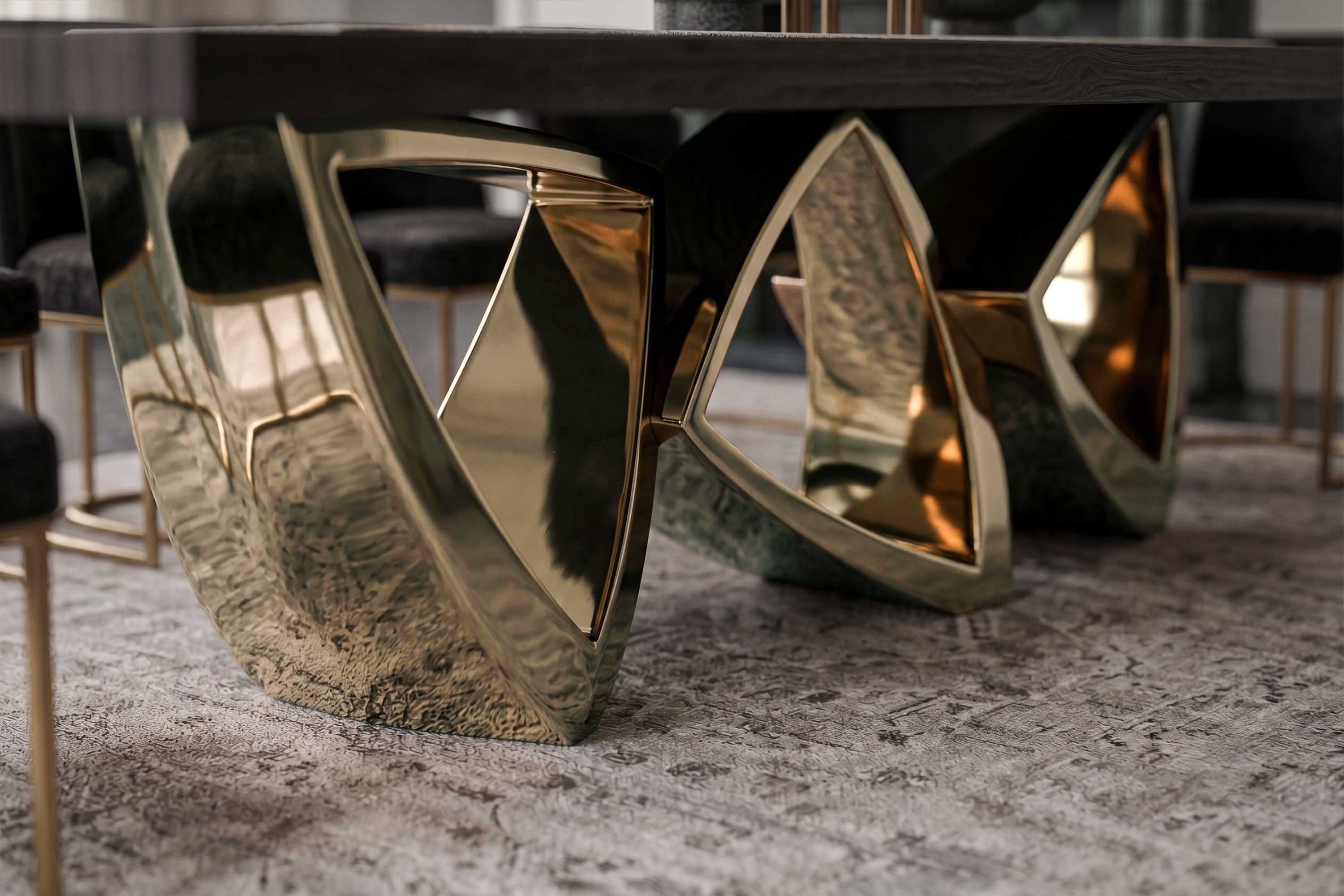 Arcos Dining Table in polished bronze, sculptural arc-base dining table staged in a refined atelier setting — Palena Studio