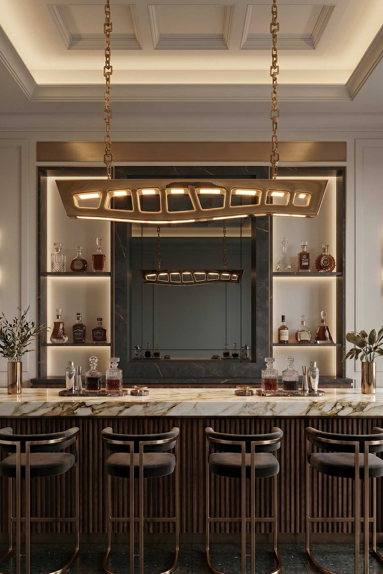 A modern home bar with marble countertop, gold and wood accents, a mirrored back wall, shelves with bottles and glassware, and four barstools under a geometric gold chandelier.