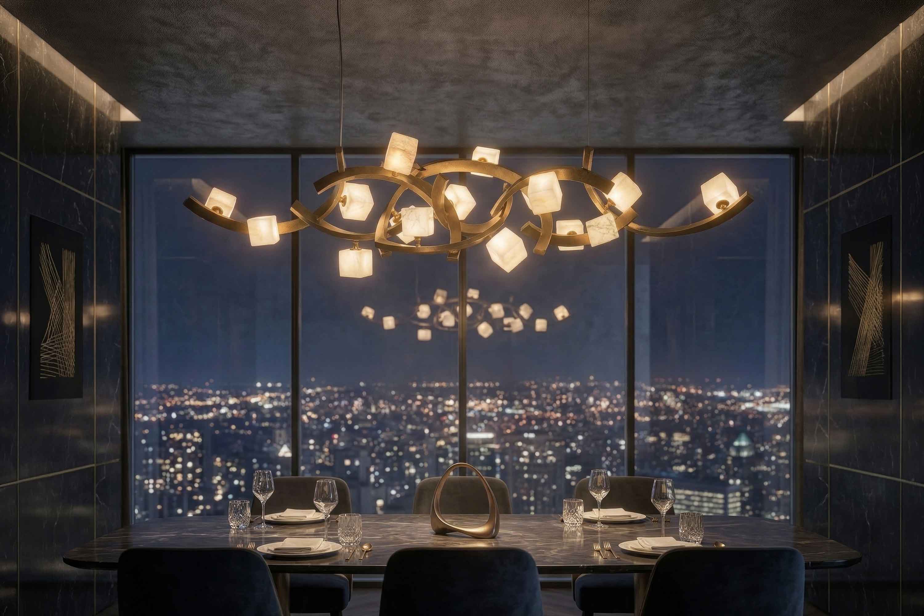 A modern dining room with a dark table set for four overlooks a city skyline at night. A sculptural chandelier with glowing cube lights hangs above the table, reflecting in the large floor-to-ceiling window.
