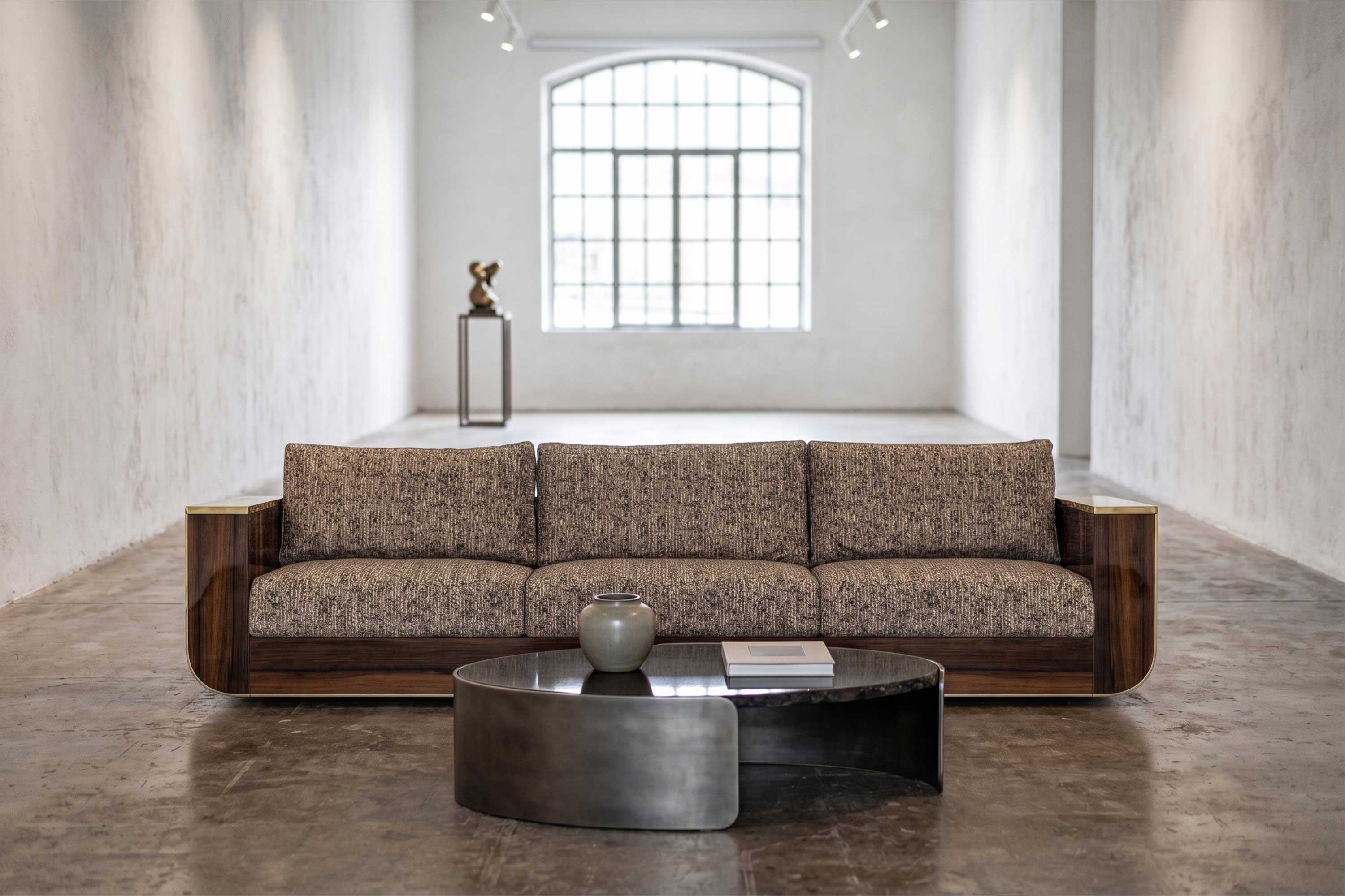 Forte Sofa in walnut frame with light upholstery, sculptural luxury sofa staged in a bright open contemporary living space — Palena Studio