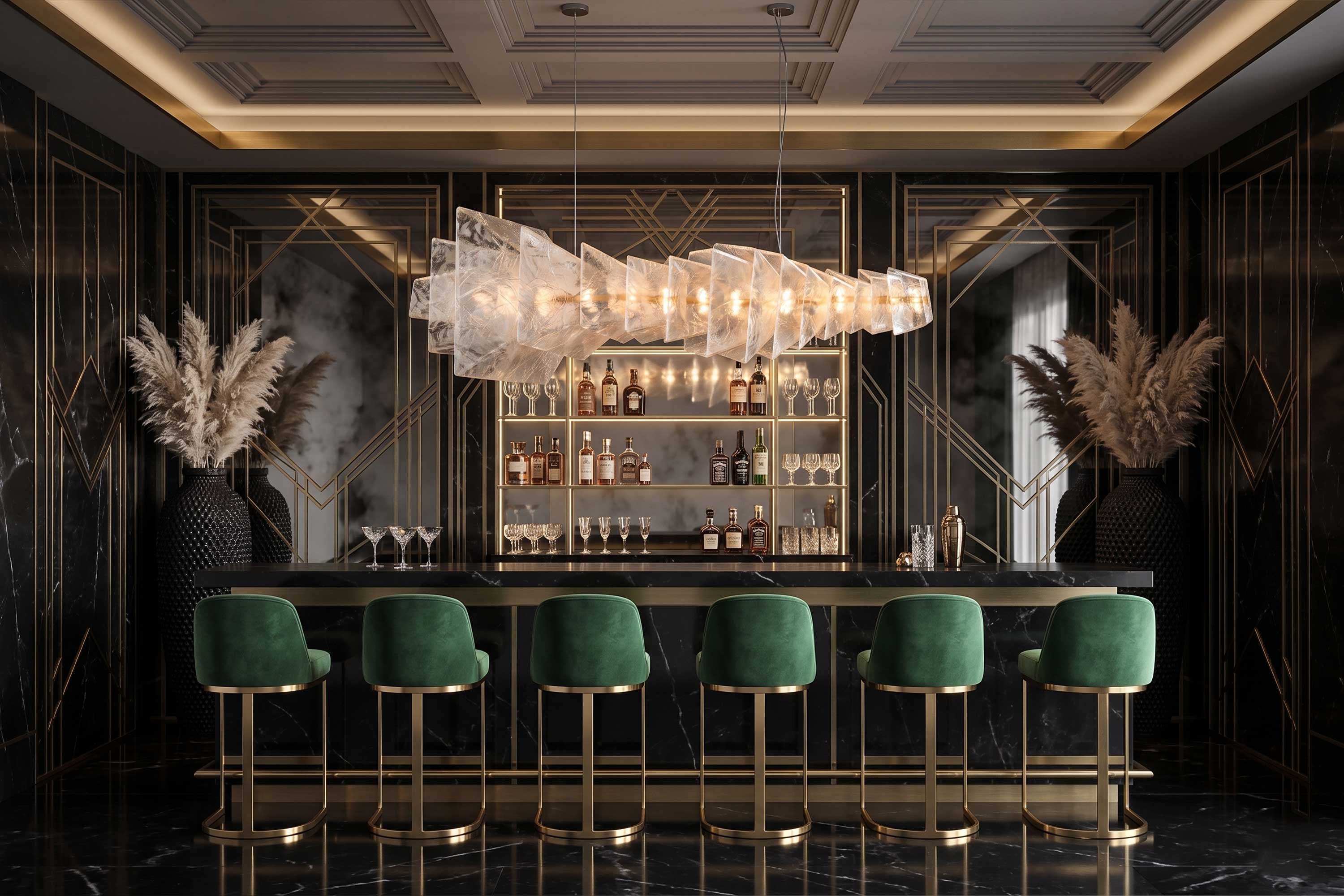 A modern upscale bar with a black and gold art deco design, green velvet bar stools, a glass chandelier, shelves with liquor bottles and glasses, and two large vases with pampas grass on either side.