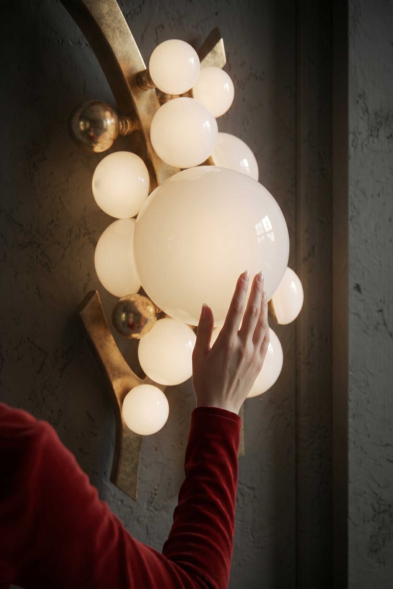 Intima Sconce, sculptural cluster wall light with large frosted glass spheres staged in a warm dark contemporary interior — Palena Studio