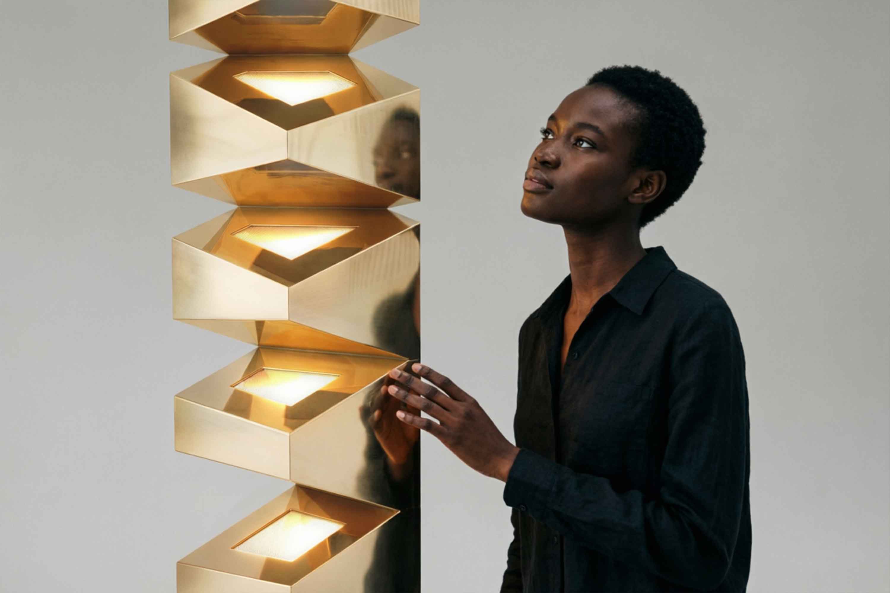 Iziz Floor Lamp in polished bronze, stacked sculptural floor lamp staged against a dark editorial backdrop, Palena Studio