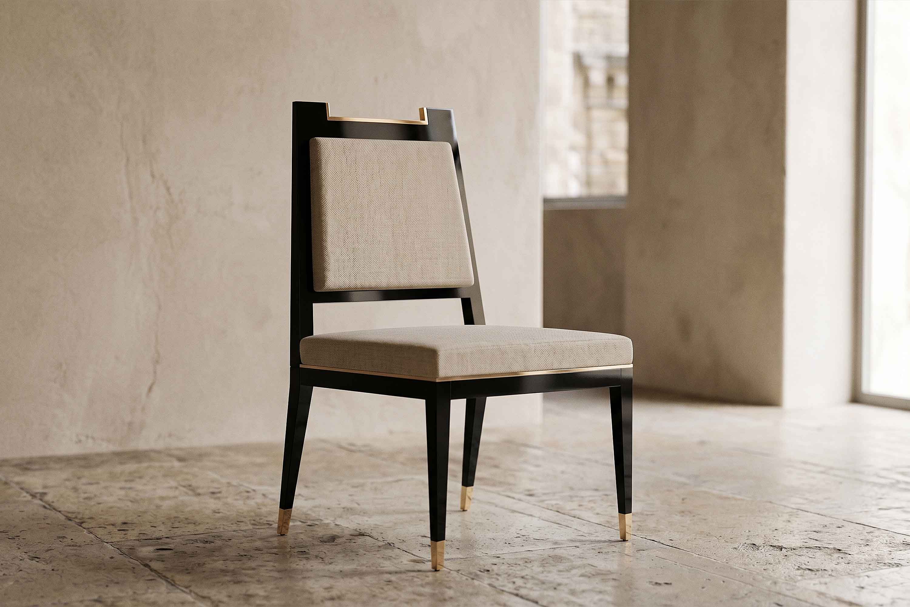 A black wooden chair with beige cushioning on the seat and backrest stands on a stone-tiled floor in a minimalistic room with neutral walls and natural light coming from a large window.