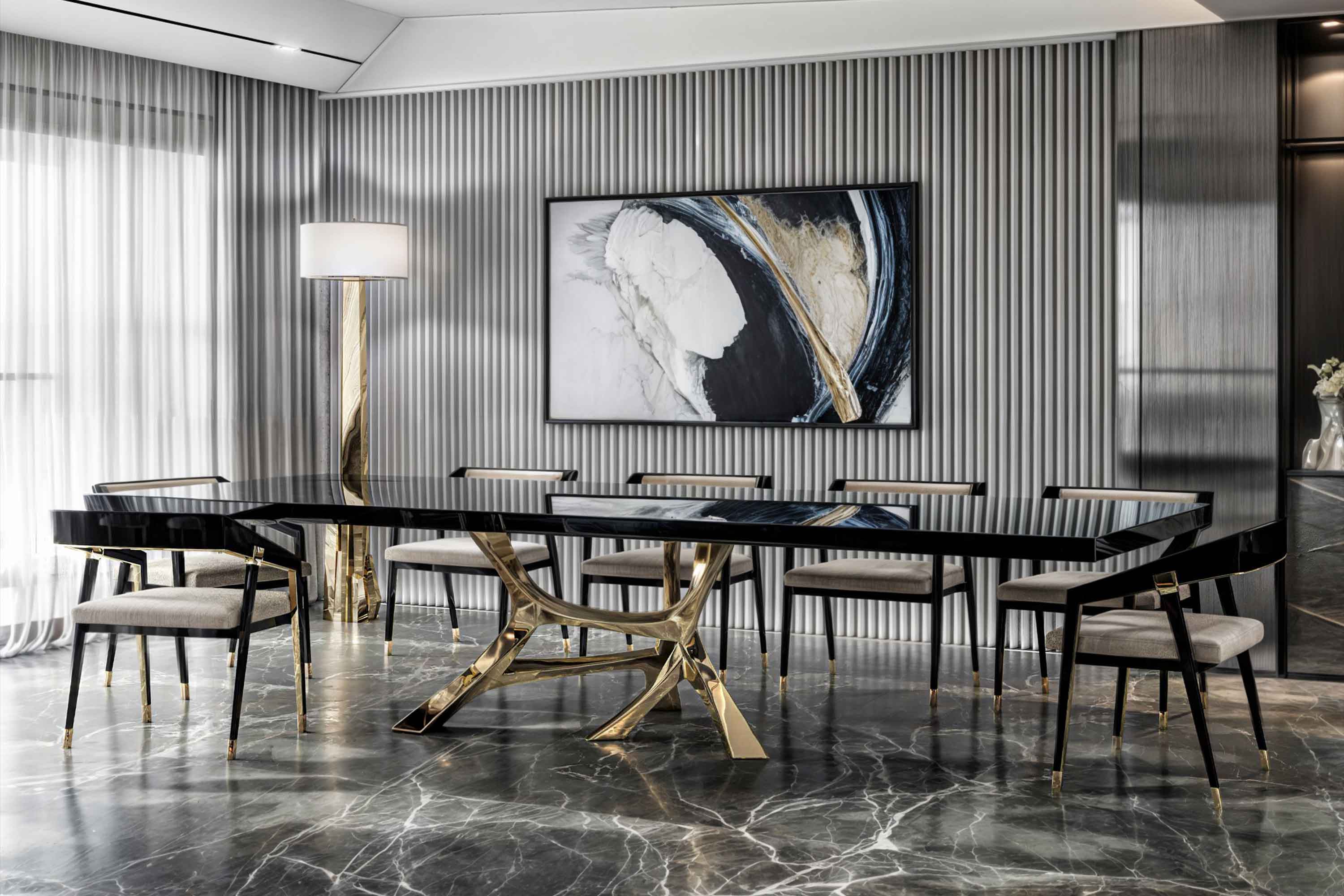 Modern dining room with a black glass table, six chairs with light cushions, a tall gold floor lamp, abstract wall art, and a marble floor. Vertical wall panels and sheer curtains are visible in the background.