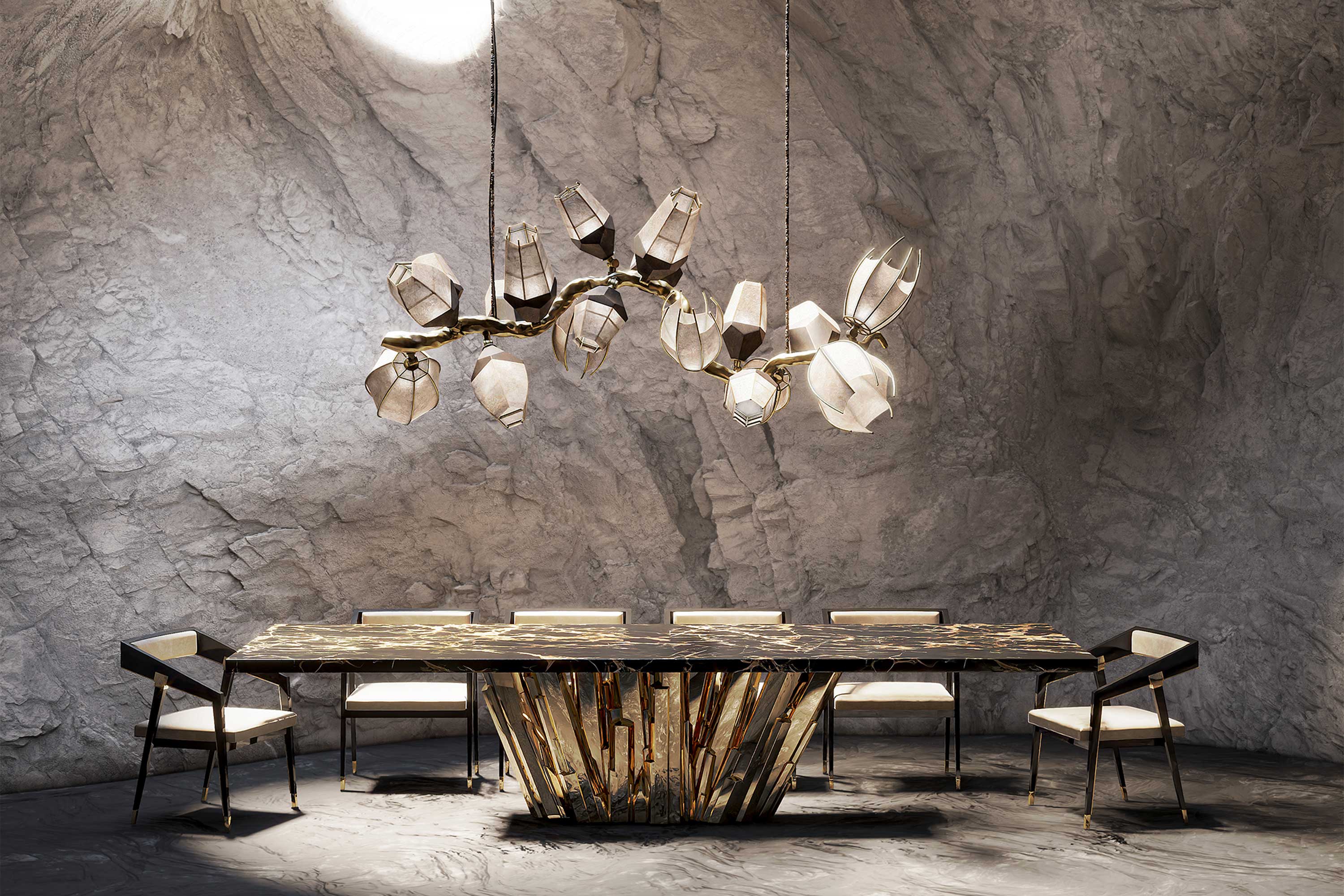 A modern dining room with a geometric black and gold table, six white cushioned chairs, and a sculptural chandelier, set against textured gray stone walls and floor. Light enters from a circular ceiling opening.