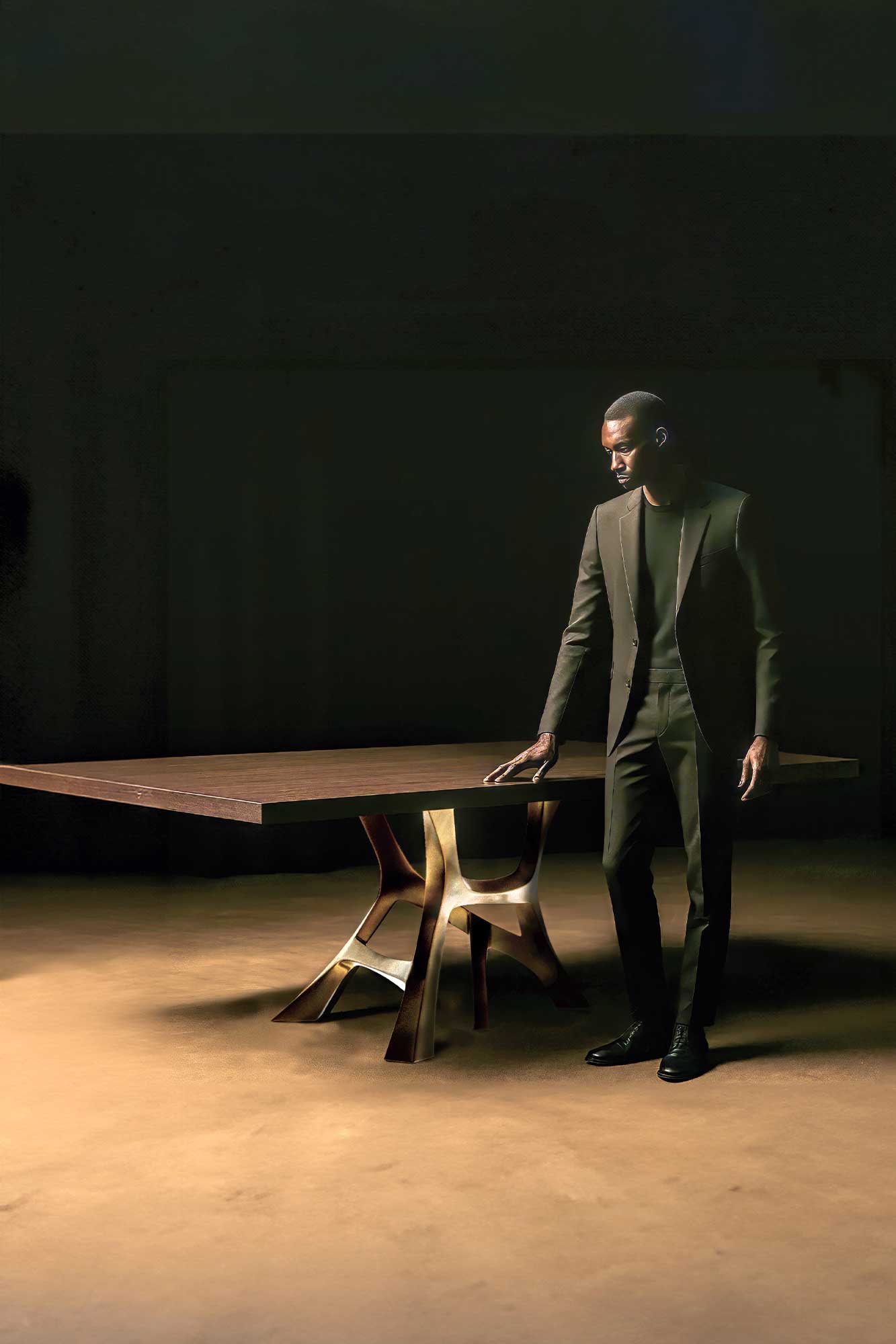 Vena Dining Table in patina bronze, sculptural flowing-base dining table staged in a dark moody interior — Palena Studio