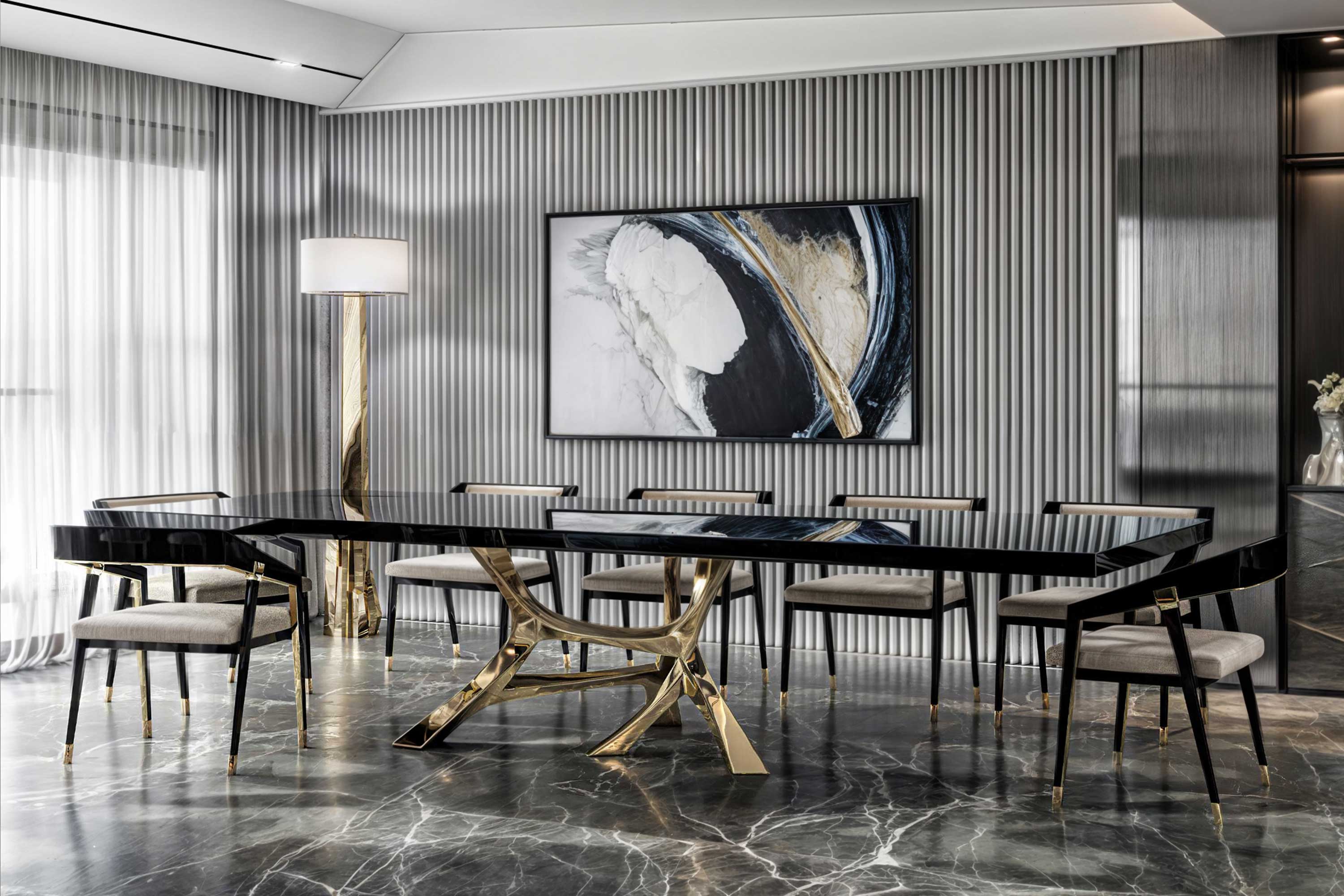 Vena Dining Table in polished bronze, sculptural flowing-base dining table staged in a bright minimal interior with large windows — Palena Studio