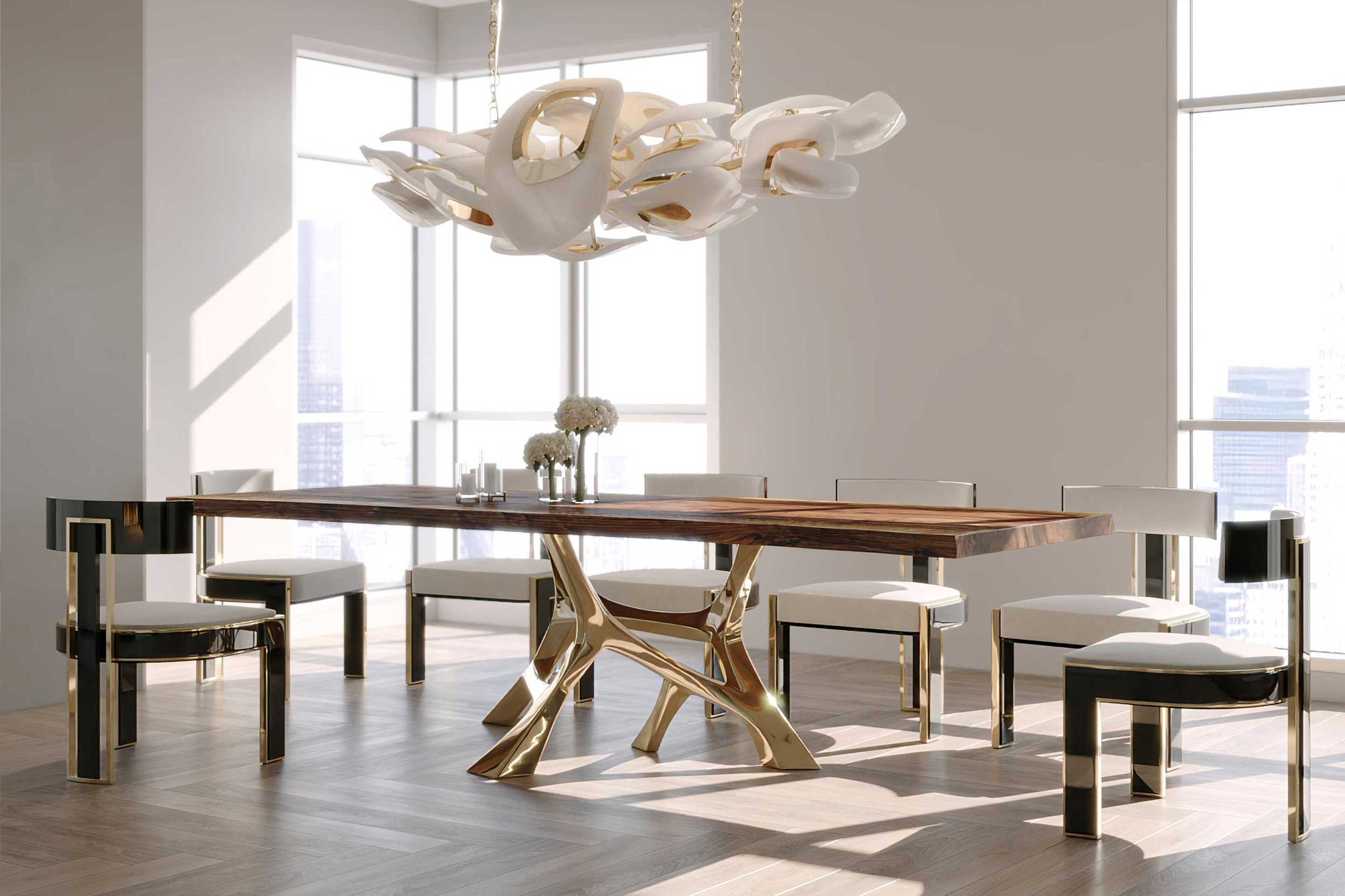 Vena Dining Table in polished bronze with sculptural base, luxury dining table staged in a warm interior with Swan chandelier above — Palena Studio