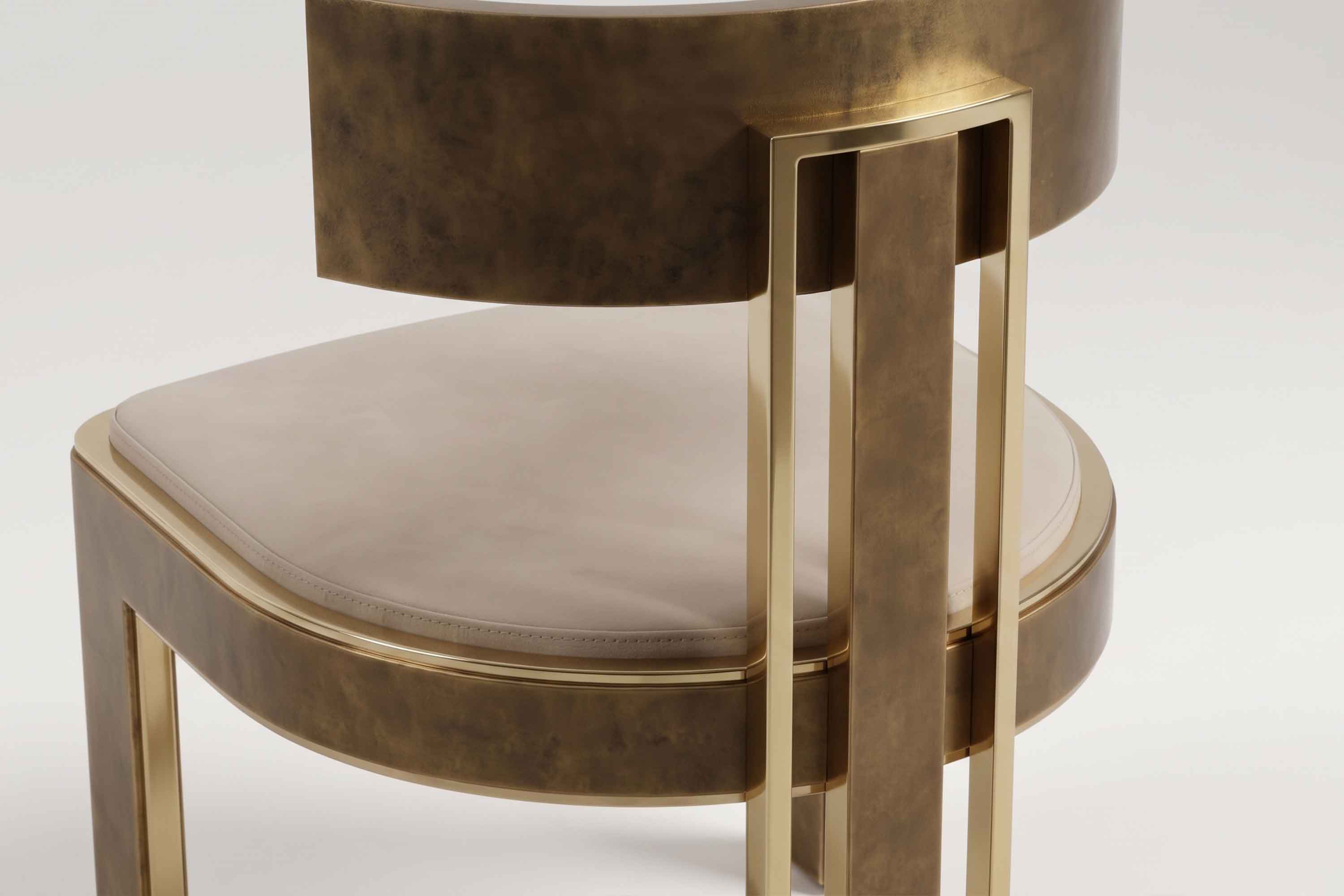 Close view of the Bellus chair's curved back panel in hand-finished patina bronze.