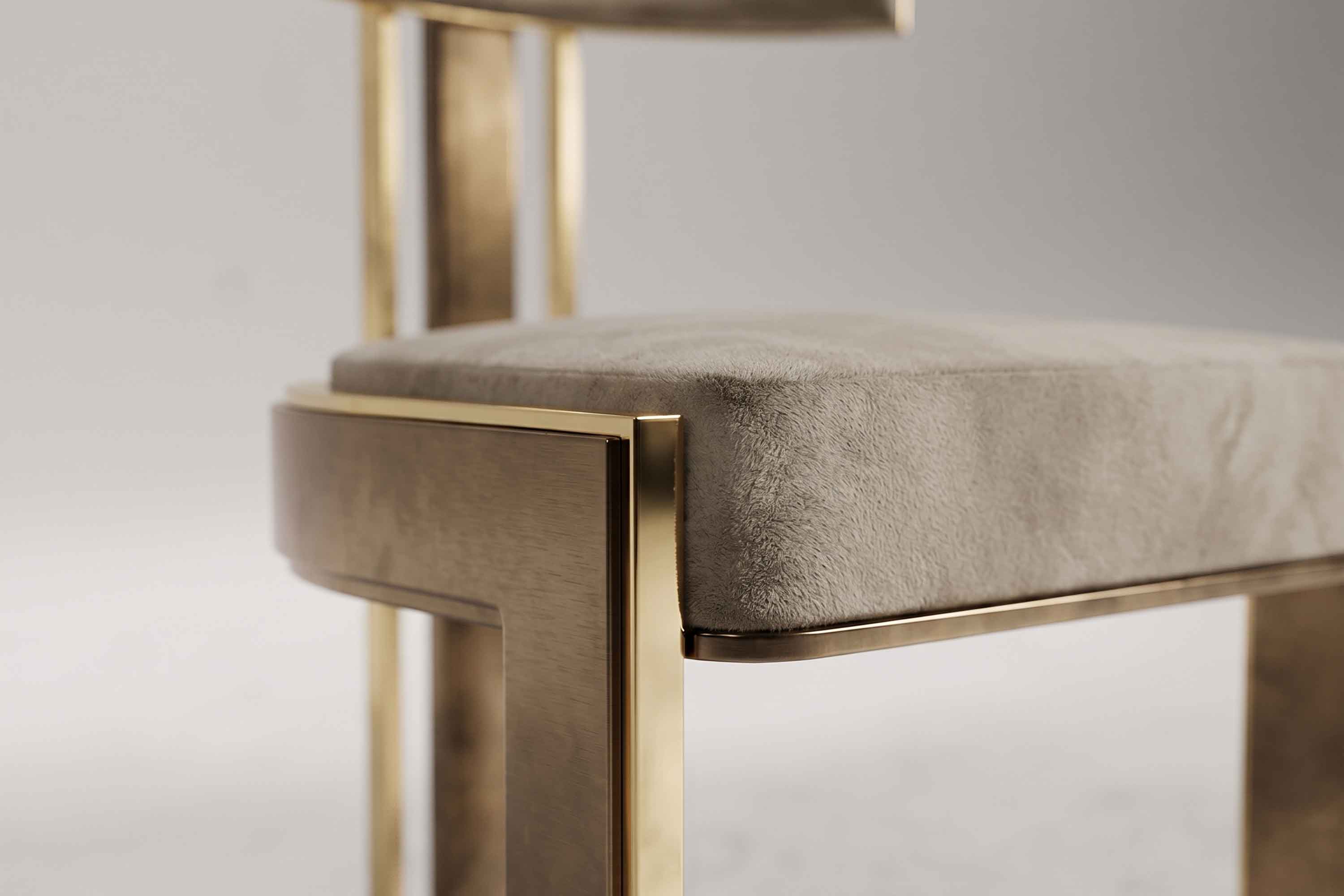Detail of the Bellus chair's patina bronze edge running along the upholstered seat.