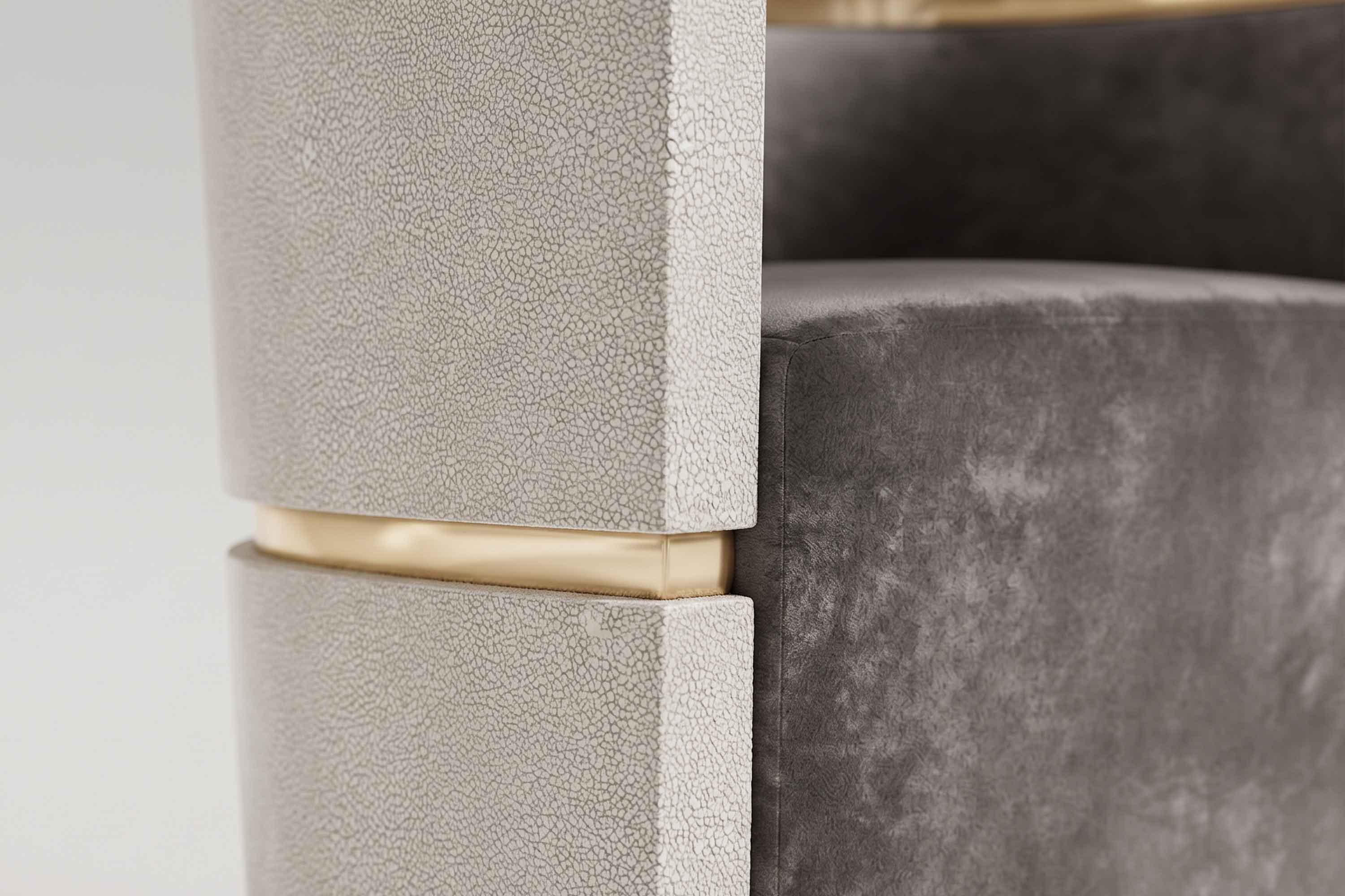Detail of the Flavius chair's beaded shagreen surface beside a polished bronze band.