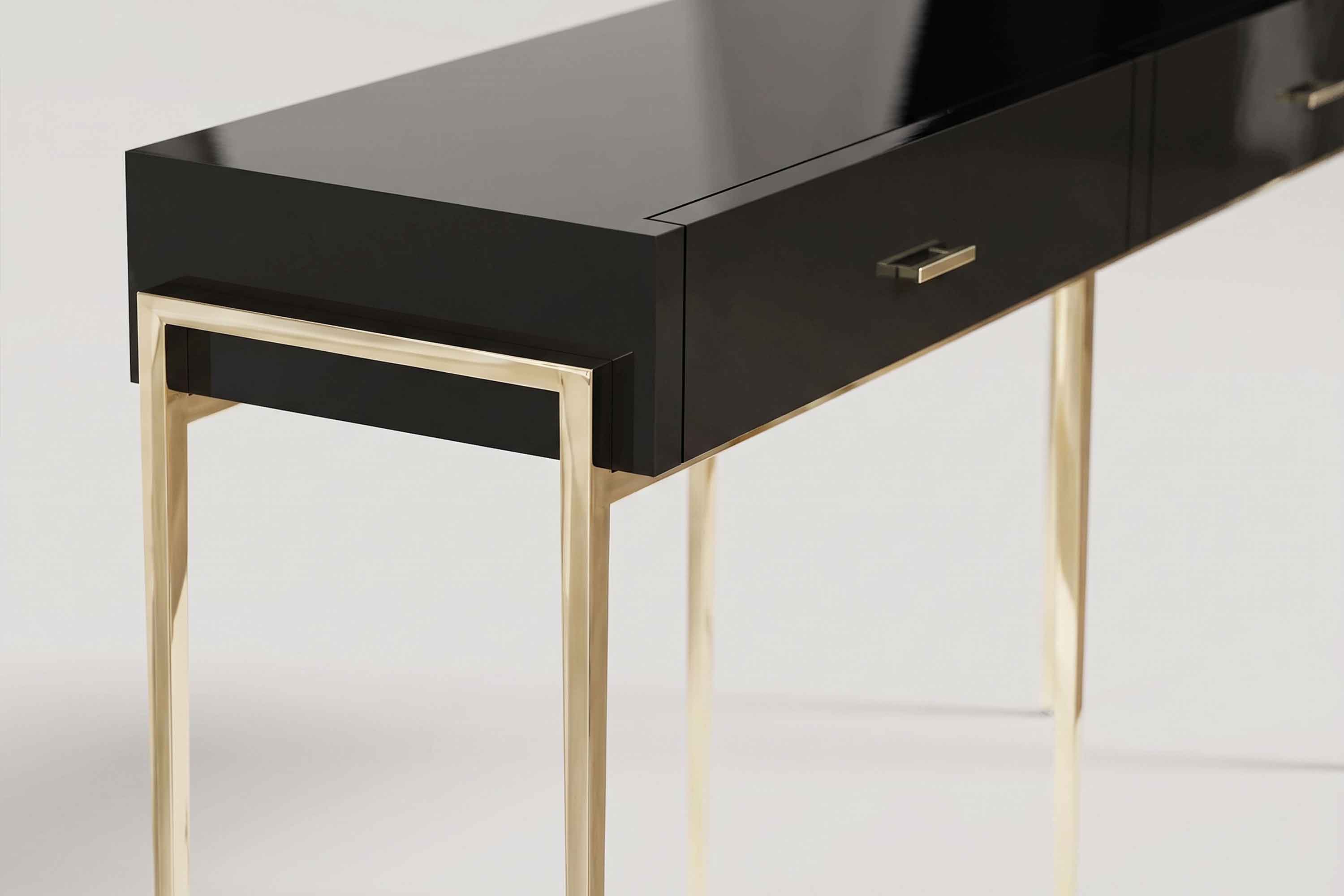 Piano Console, detail of a black lacquer drawer with a slim polished bronze handle above a slender polished bronze leg.